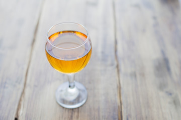 Orange juice in a glass glass on a white cloth on a wooden table
