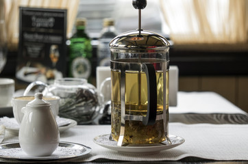 Transparent glass teapot with tea