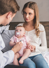 Baby at the pediatricians © georgerudy