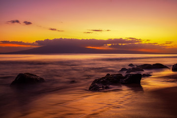 Fototapeta na wymiar Sunset with rocks and beach