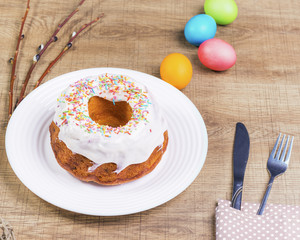 Festive table with colorful  eggs and  cupcake