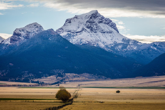 Amazing autumn landscape. The beautiful mountain's peak is covered with snow. Montana, USA