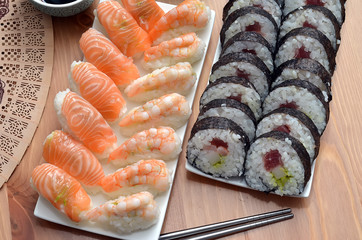 maki sushi rolls and nigiri sushi with salmon and shrimp japan food on the table detail