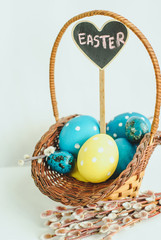 Happy Easter concept. Wicker basket full of colorful painted eggs on white background