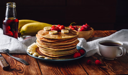Pancakes with Fruits, Maple Syrup and Cup of Tea.