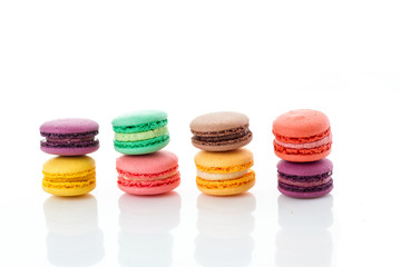 Towers from colourful macaroons on white background linear