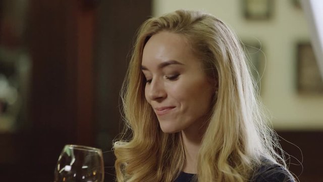 lonely blondie drinking red wine in restaurant