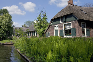 Fototapeta na wymiar Giethoorn water village the Netherlands. Overijssel. Canals. Farmhouses. 