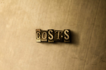 COSTS - close-up of grungy vintage typeset word on metal backdrop. Royalty free stock illustration.  Can be used for online banner ads and direct mail.