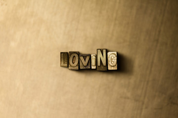 LOVING - close-up of grungy vintage typeset word on metal backdrop. Royalty free stock illustration.  Can be used for online banner ads and direct mail.