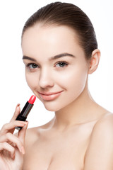 Beautiful model girl holding lipstick tube makeup