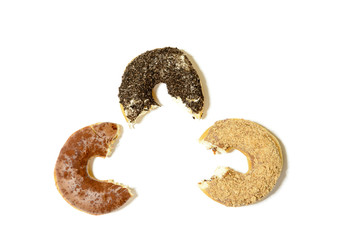 three donuts with sprinkles and a bitemark, isolated on white background