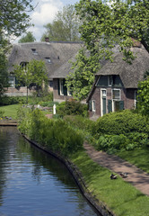 Fototapeta na wymiar Giethoorn village the Netherlands. Overijssel. Canals. Farmhouses. Bridges.