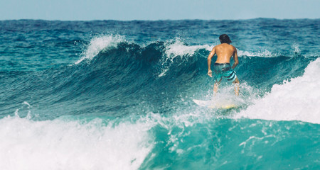 Male surfer riding the waves of the Atlantic Ocean