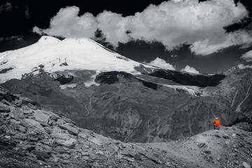 A lone tourist among the big mountains. Black and white photo. - 137981852