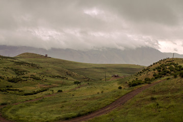 House on the Hill in Mountains and Winding Mountain Road