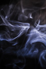 smoke curls on black background