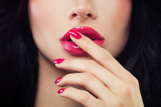 Woman Touching her Lips her Hand with Manicure. Makeup Lips with Pink Glossy Lipstick
