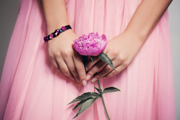 Beautiful Peony Flower in Female Hands on Lacy Prom Skirt © millaf (Nemchinova)