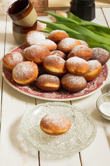 Polish donuts, doughnuts. Wooden table, white background. 
