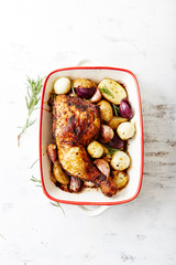 Oven-roasted chicken leg with potatoes, olives and rosemary