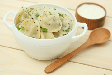russian pelmeni on wood background