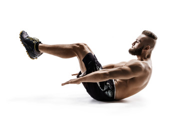 Fitness man doing exercises for the swing press. Side view of young man in sportswear isolated on white background. Strength and motivation.