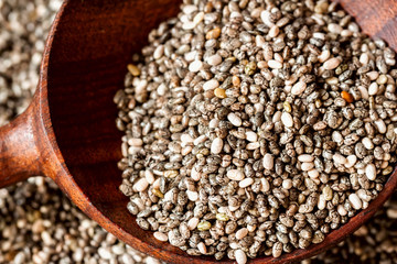 Wooden spoon and organic chia seeds. Macro. Concept of detox and healthy eating. For background , backdrop, substrate, composition use.
