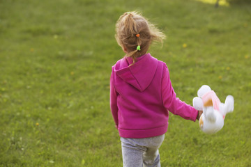 Fototapeta premium Little girl kid playing, having fun. outdoors