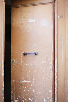 Old peeling door in a small street of Palermo. Italy