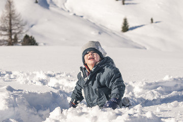 Fototapeta na wymiar Young boy on snow covered field