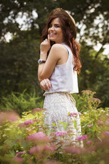 Young beautiful caucasian white brunette woman with curly hairstyle and make up, in a summer...
