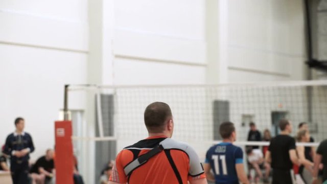 People playing volleyball indoors shot
