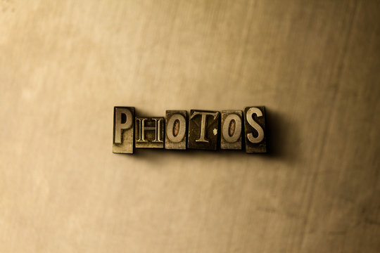 PHOTOS - close-up of grungy vintage typeset word on metal backdrop. Royalty free stock illustration.  Can be used for online banner ads and direct mail.