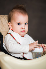 baby drinking milk from a bottle in the apartment