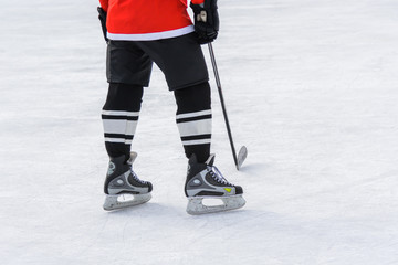 hockey player with a stick standing on ice