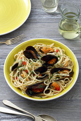 pasta italiana spaghetti con le cozze sfondo tavolo di cucina grigio