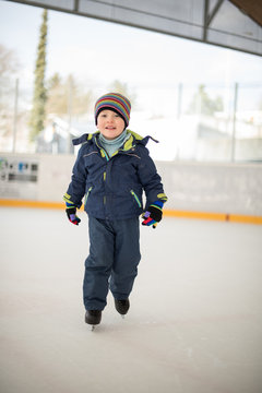 Winter sport. Small boy skating on ice 