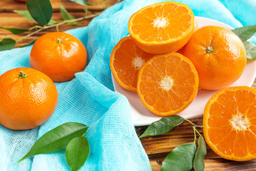 Fresh citrus fruits tangerines, oranges closeup in rustic style