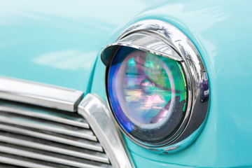 Headlight of vintage vehicle close up shot - car of Island Paradise.