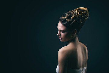 Portrait d'une jeune femme portant un chignon, de profil 