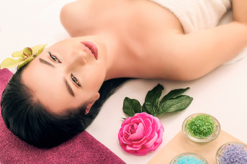 Obraz na płótnie Canvas spa, beauty, people and body care concept - beautiful woman getting face treatment over holidays light background
