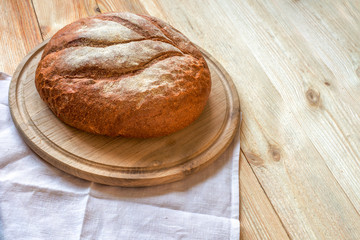 Fresh fragrant bread on the wooden table.