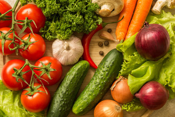 raw vegetables on a round wooden Board. top view. 