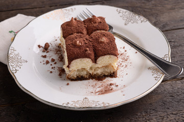 Portion of tiramisu on decorated saucer