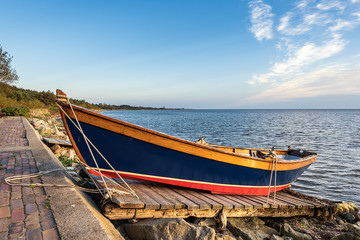 Wooden colorful boat left on the shore. Baltic Sea, Poland.