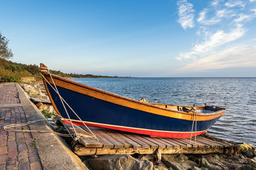 Obraz premium Wooden colorful boat left on the shore. Baltic Sea, Poland.