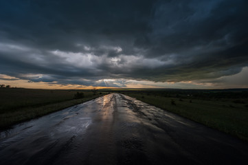 Very Dark Wet Road During the Rain and the Sunset.  Stormy Road Horizon Landscape Weather Sunset  Rain  Danger Rural  Dramatic