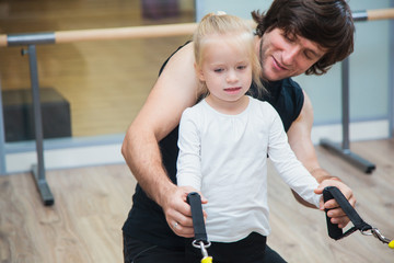 Fototapeta na wymiar Pilates coach training child using special equipment.