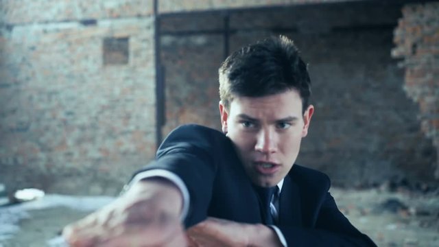 Businessman showing movements of martial arts. 4k